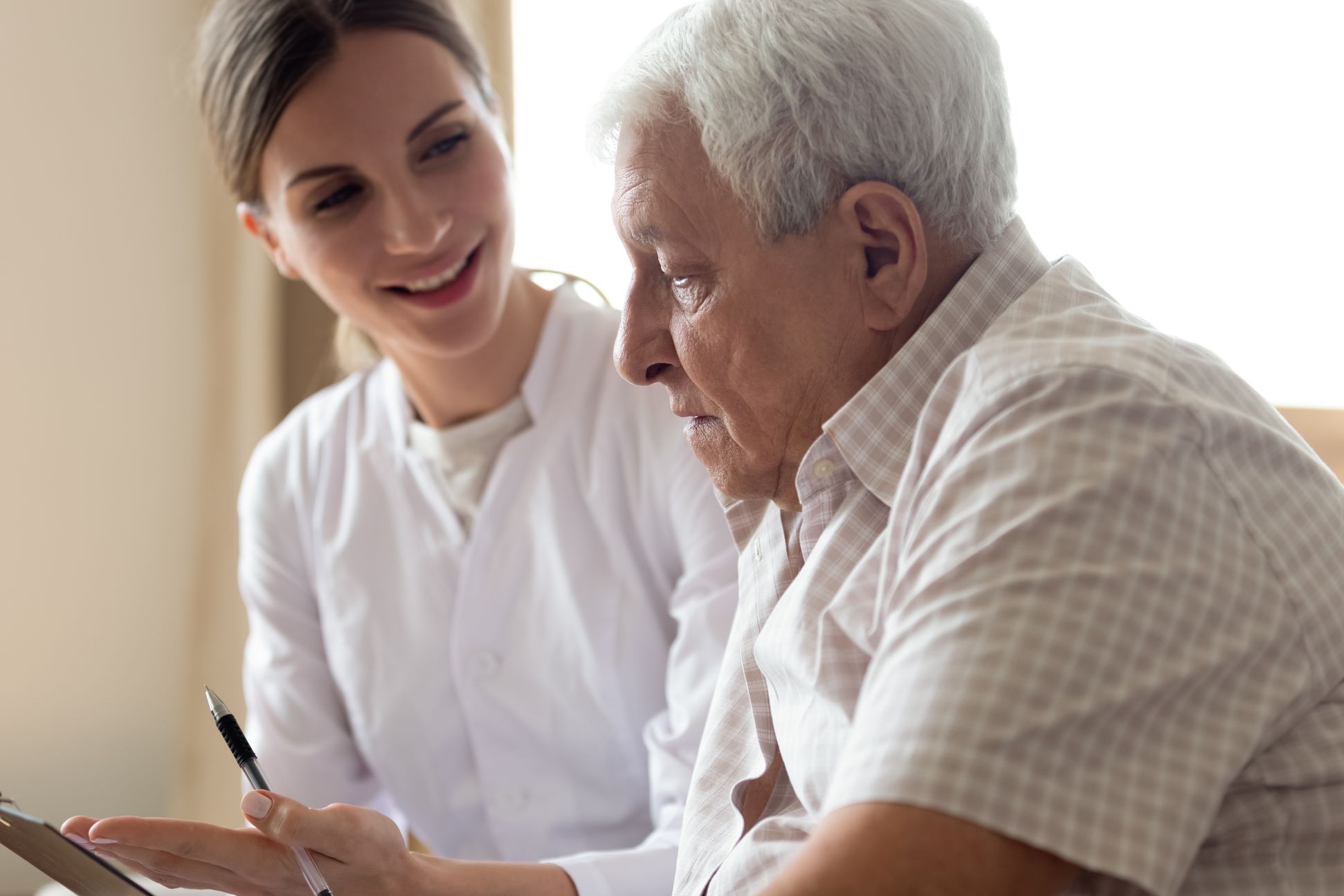 Senior man speaks with Medicare SHIP counselor.